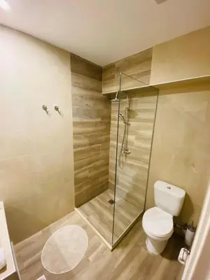 a bathroom with a toilet and a glass shower at Block66 in Rhodes Town