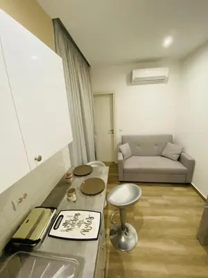 a living room with a couch and a table at Block66 in Rhodes Town