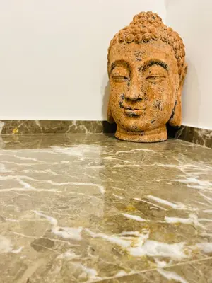 a statue of a head sitting on a floor at Block66 in Rhodes Town