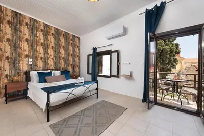 a bedroom with a bed and a balcony at Emerald Dream House, Aithria in Rhodes Town