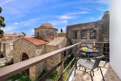 a balcony with a table and chair on a building at Emerald Dream House, Aithria in Rhodes Town