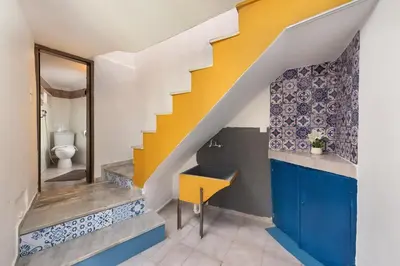 a staircase in a bathroom with a yellow and blue stair at Emerald Dream House, Aithria in Rhodes Town