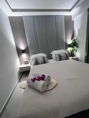 a bedroom with two beds with towels on them at Odyssea Front Beach in Kremasti