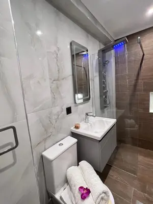 a bathroom with a toilet and a sink and a shower at Odyssea Front Beach in Kremasti