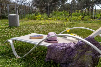 a hat and a book sitting on a chair at Gennadi Beach Front in Gennadi