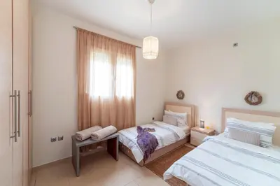 a bedroom with two beds and a window at Gennadi Beach Front in Gennadi