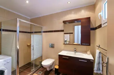 a bathroom with a toilet and a sink and a shower at Gennadi Beach Front in Gennadi