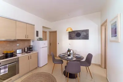 a kitchen with a table and chairs in a room at Gennadi Beach Front in Gennadi
