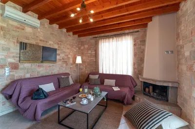 a living room with two couches and a fireplace at Gennadi Beach Front in Gennadi