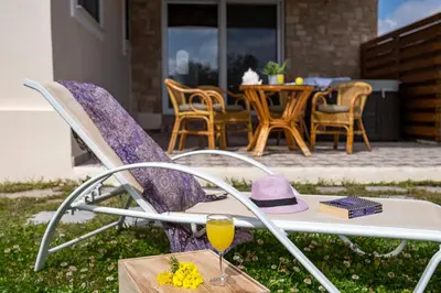 a chair with a hat and a glass of wine at Gennadi Beach Front in Gennadi