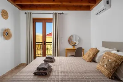 a bedroom with a bed with towels on it at Symiland Villa in Symi