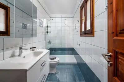 a bathroom with a sink and a toilet at Symiland Villa in Symi