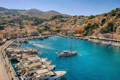 a group of boats docked in a harbor with buildings at Symiland Villa in Symi