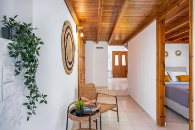 a room with a table and chairs and a bed at Nimporio View Villa in Symi