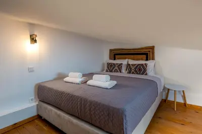 a bedroom with a large bed with two towels on it at Nimporio View Villa in Symi