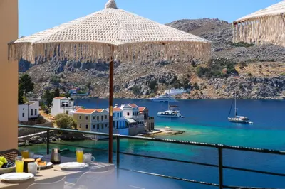 a view of the ocean from a hotel balcony at Nimporio View Villa in Symi