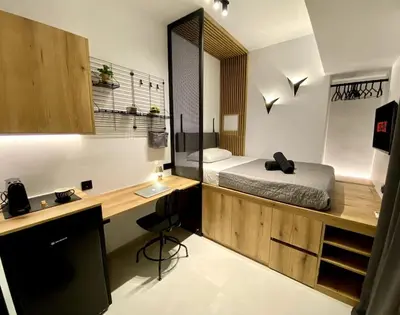 a bedroom with a bed and a desk with a desk at TinyVibe - Downtown Seabreeze Studio in Rhodes Town