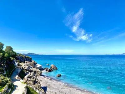 a view of a beach with blue water and rocks at TinyVibe - Downtown Seabreeze Studio in Rhodes Town