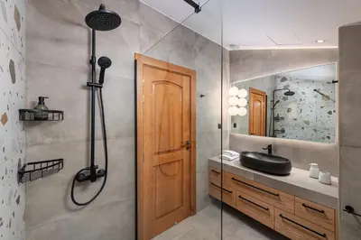 a bathroom with a shower and a black sink at Greenheart - Mediterranean Elegance in Nature in Ialyssos