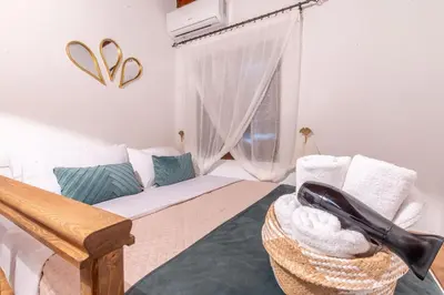 a living room with a couch and a window at Mascot Memories in Rhodes Town