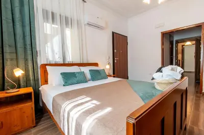 a bedroom with a large bed and a window at Mascot Memories in Rhodes Town