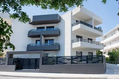 a white building with balconies and a fence at Rhodes Center Apartment in Rhodes Town