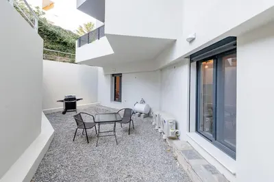 a patio with a table and chairs in a house at Rhodes Center Apartment in Rhodes Town