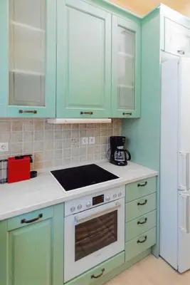 a kitchen with green cabinets and a stove top oven at Ivi CentralApartment Rhodes Town in Rhodes Town