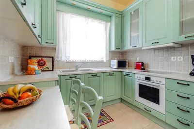 a kitchen with green cabinets and a bowl of fruit on a counter at Ivi CentralApartment Rhodes Town in Rhodes Town