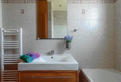 a bathroom with a sink and a mirror and a tub at Ivi CentralApartment Rhodes Town in Rhodes Town