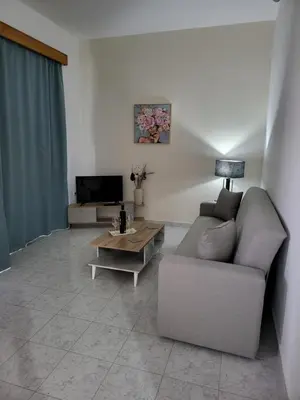 a living room with a couch and a coffee table at Pyrgos Hotel Apartments in Kremasti