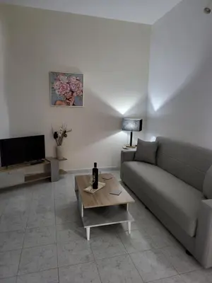 a living room with a couch and a table at Pyrgos Hotel Apartments in Kremasti