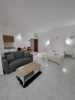 a living room with a couch and a coffee table at Pyrgos Hotel Apartments in Kremasti