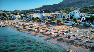 an aerial view of a beach with chairs and umbrellas at La mer stegna in Archangelos