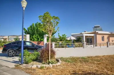 a car parked in front of a house at Paul’s Garden Luxury House in Haraki