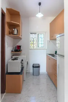 a kitchen with a microwave on a counter next to a refrigerator at Beachside Apartment-1 in Afantou