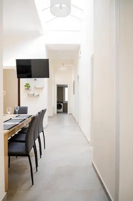 a dining room with a table and chairs at Alcestis City Apartment in Rhodes Town