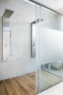 a bathroom with a shower with a glass door at Alcestis City Apartment in Rhodes Town