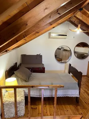 a bedroom with a bed and a table in a room at Aeneo Studio 1 in Symi