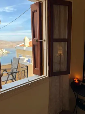 a window with a view of a balcony at Aeneo Studio 1 in Symi