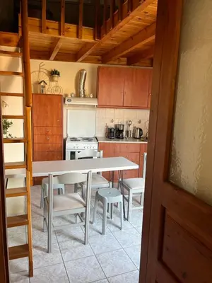 a kitchen with a table and chairs and a stove at Aeneo Studio 1 in Symi