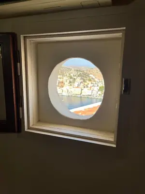 a window in a bathroom with a view of the water at Aeneo Studio 1 in Symi