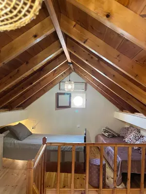 a attic room with a bed and a staircase at Aeneo Studio 1 in Symi