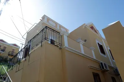 a building with a balcony on the side of it at Aeneo Studio 1 in Symi