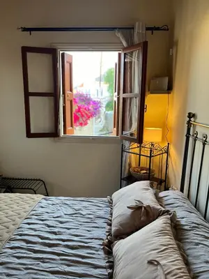 a bedroom with a bed and a window at Aeneo Studio 1 in Symi
