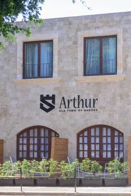 an entrance to an apartment building with windows at Arthur Suites in Old Town in Rhodes Town