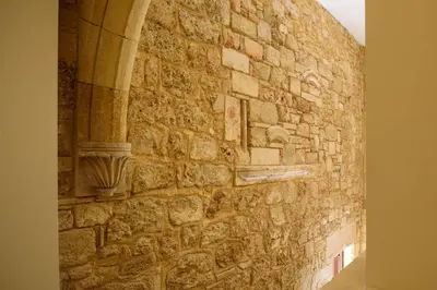 a stone wall with a stone carving on it at Arthur Suites in Old Town in Rhodes Town