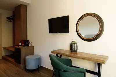 a room with a table and a mirror and a chair at Arthur Suites in Old Town in Rhodes Town