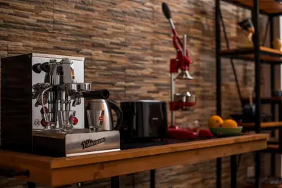 a kitchen counter with a juicer on a table at La Vie Est Belle in Ixia