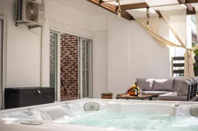 a jacuzzi tub in the middle of a living room at La Vie Est Belle in Ixia